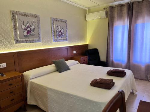 Ένα ή περισσότερα κρεβάτια σε δωμάτιο στο Hotel Don Juan