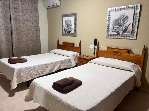 Ένα ή περισσότερα κρεβάτια σε δωμάτιο στο Hotel Don Juan
