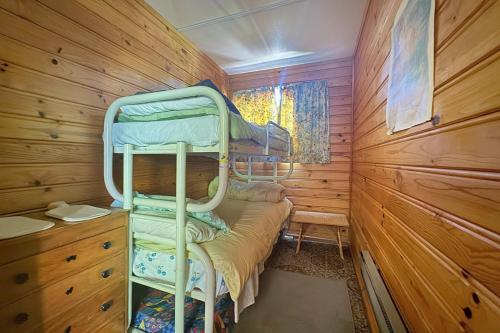 a bedroom with bunk beds in a wooden cabin at 8 Leamington Street in Hanmer Springs
