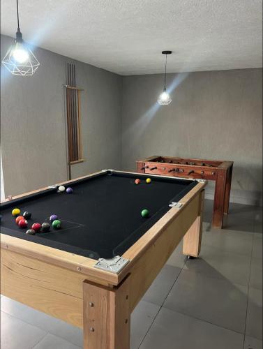 a room with a pool table with balls on it at Espaço de festas e Hospedagem Cintia Lima in Betim