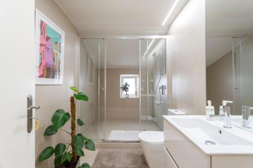 a bathroom with a shower and a toilet and a sink at Suite in Cozy Apartment in Chiado in Shared House in Lisbon