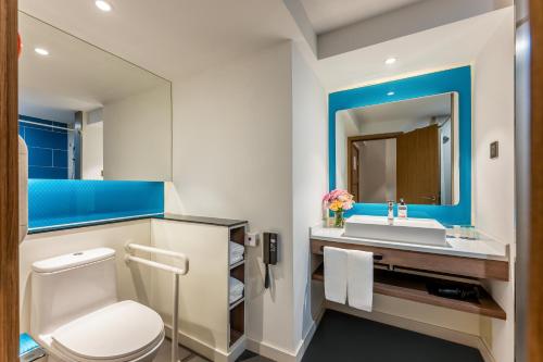 a bathroom with a white toilet and a sink at Holiday Inn Express Tianjin Airport East by IHG in Tianjin