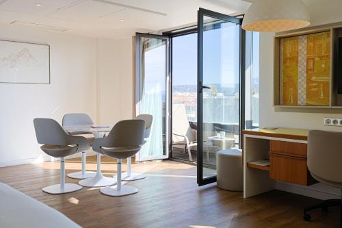 a meeting room with a table and chairs and a view at Renaissance Aix-en-Provence Hotel in Aix-en-Provence
