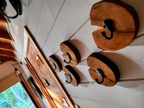 a row of wooden musical instruments hanging on a wall at Cabañas Alto del Bosque in Coñaripe