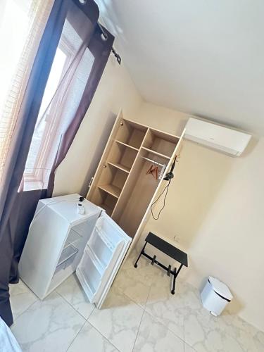 a room with a refrigerator and a table in it at Twin Room with Private Bathroom - Room 1 in Tal-Għoqod