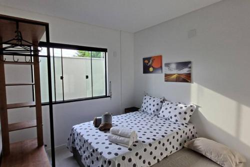 a bedroom with a bed with polka dot sheets at APTO NOVO - Praias, Beto Carrero e Aeroporto in Navegantes