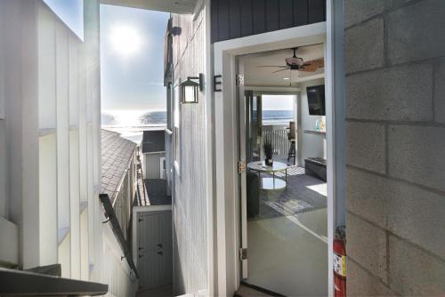 an open door to a balcony with a view of the ocean at The Shining Sea E in Oceanside