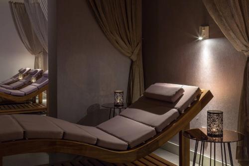 a room with a bed with two tables and curtains at Le Meridien Lav Split in Podstrana