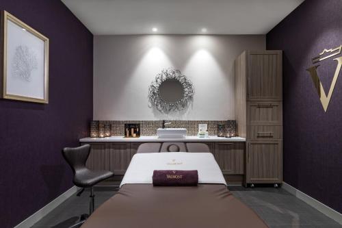 a spa room with a bed and a mirror at Le Meridien Lav Split in Podstrana