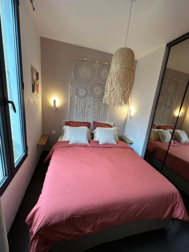 a bedroom with a large bed with a red blanket at Appartement Nice Promenade in Nice