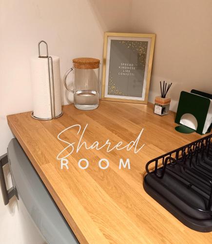 a wooden desk with a shaded room sign on it at Comfy Stay 9052 in Ghent