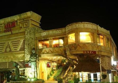 a building with a statue in front of it at Spazio Boutique Hotel in Cancún