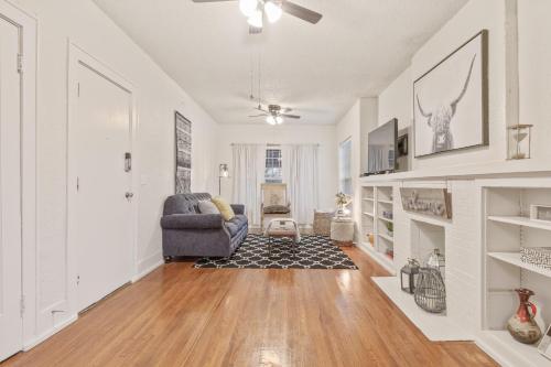 a living room with a chair and a fireplace at Carson Flats Apt 5 - 1BR Near BOK, OSU Med, Dtwn in Tulsa