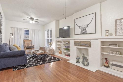 a living room with a couch and a fireplace at Carson Flats Apt 5 - 1BR Near BOK, OSU Med, Dtwn in Tulsa