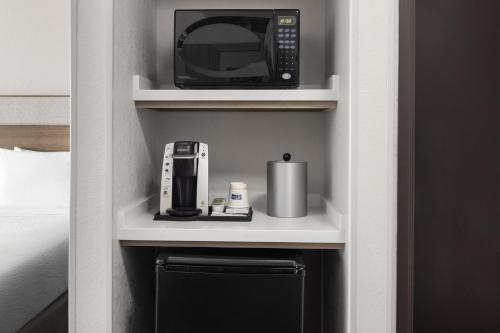 a microwave on a shelf in a hotel room at Holiday Inn Express & Suites Midland Loop 250 by IHG in Midland