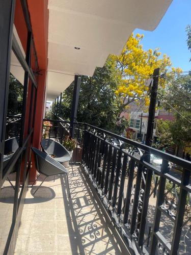 a balcony of a building with a table and a railing at Casa Hotel Marchel in Tequila