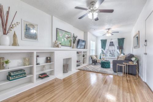 a living room with white walls and a ceiling fan at Carson Flats Apt 6 - 1BR Near BOK, OSU Med, Dtwn in Tulsa