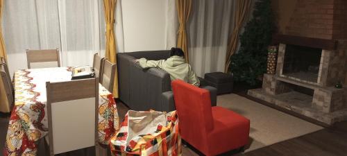 a person laying on a couch in a living room at Altos de Quiluva in Suesca