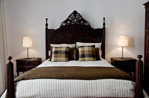 a bedroom with a large bed with two lamps at Chiado Lisbon Apartment in Lisbon
