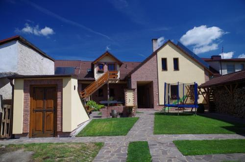 a house with a staircase in a yard at Ubytování a apartmány Sluníčko in Lomnice nad Lužnicí