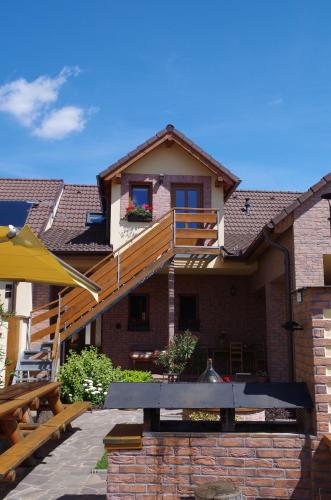 a house with a wooden deck on top of it at Ubytování a apartmány Sluníčko in Lomnice nad Lužnicí