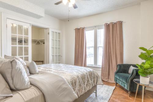 a bedroom with a bed and a chair and a window at Carson Flats Apt 2 - 1BR Near BOK, OSU Med, Dtwn in Tulsa