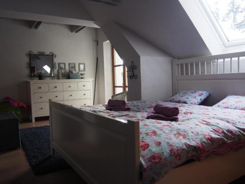 a bedroom with a bed and a dresser and a window at Chalúpka pod Lipkami in Kremnica