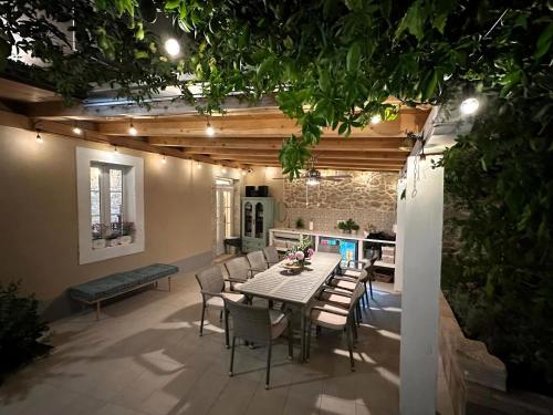 a patio with a table and chairs and a kitchen at Cotton House in Novi Vinodolski