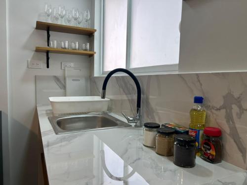 a kitchen counter top with a sink and a sink at Trendy apartment 2 bedroom 1 bath in Baños