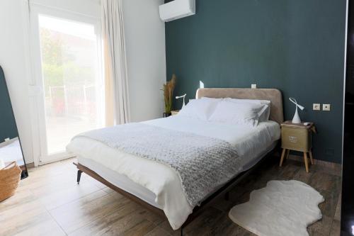a bedroom with a large bed and a large window at LĀr - the Hidden Gem in Anatolí