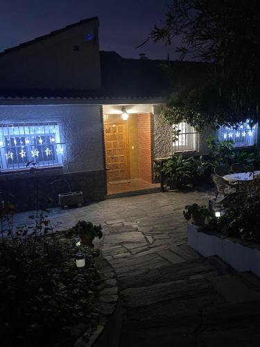 a house lit up at night with a patio at Casa rural Balcón de Monachil in Monachil