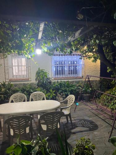 a patio with a table and chairs and a tree at Casa rural Balcón de Monachil in Monachil