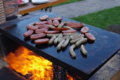 a bunch of meat and sausages cooking on a grill at Ubytování a apartmány Sluníčko in Lomnice nad Lužnicí