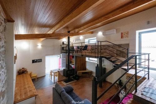 a living room with a spiral staircase in a house at Casa Ti Maria in Sorval