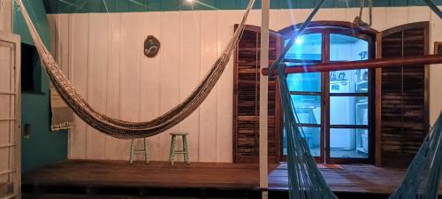 a hammock in the middle of a room at Oka do Mar - Hospedaria de Quartos e Casa na Ilha do Mel - Nova Brasília in Ilha do Mel