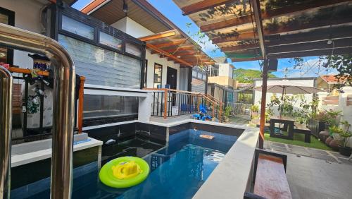 a swimming pool with a yellow frisbee in it at Jolie Joes One Bedroom Unit in Tagudin