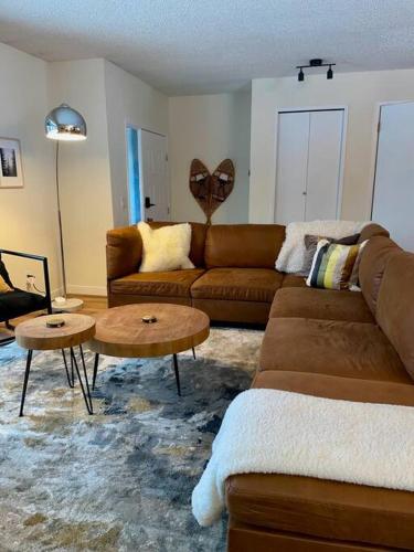a living room with a couch and a table at Nell's Mountain Lodge - Arcade Hottub Fire Pit 5 Acres in Golden