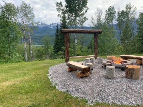 a fire pit with logs and benches on a field at Nell's Mountain Lodge - Arcade Hottub Fire Pit 5 Acres in Golden