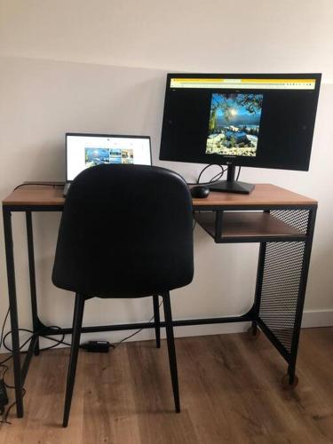 a desk with a chair and a computer monitor at Nell's Mountain Lodge - Arcade Hottub Fire Pit 5 Acres in Golden