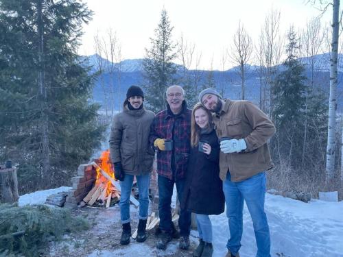 a group of people posing for a picture in front of a fire at Nell's Mountain Lodge - Arcade Hottub Fire Pit 5 Acres in Golden