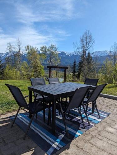 a black table and chairs on a patio at Nell's Mountain Lodge - Arcade Hottub Fire Pit 5 Acres in Golden