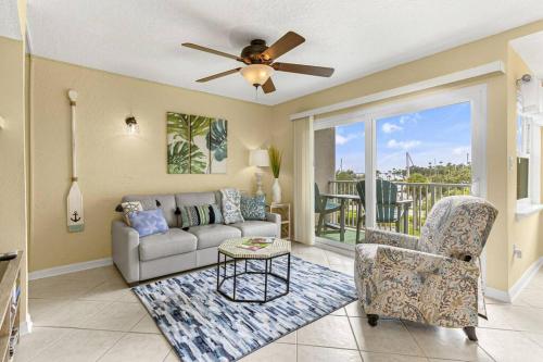 a living room with a couch and a ceiling fan at Haven Harbor Getaway in Melbourne