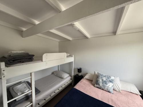 a room with two bunk beds and a bed at Picton's Waikawa Bay Holiday Park in Picton