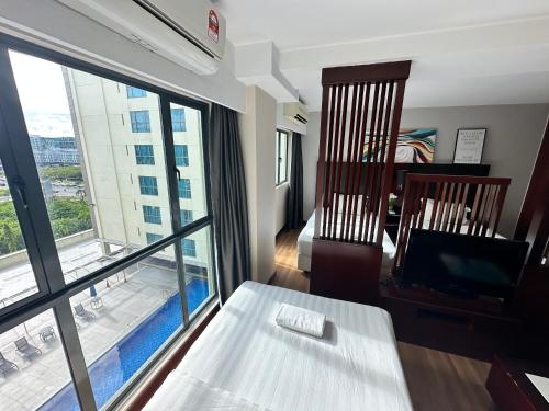 a living room with a room with a large window at Greenage MingSuite 明绿时代套房 Kota Kinabalu 亚庇市中心 in Kota Kinabalu