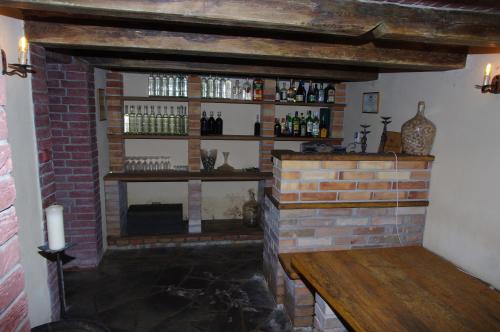 a room with a brick fireplace with a shelf at Ubytování a apartmány Sluníčko in Lomnice nad Lužnicí