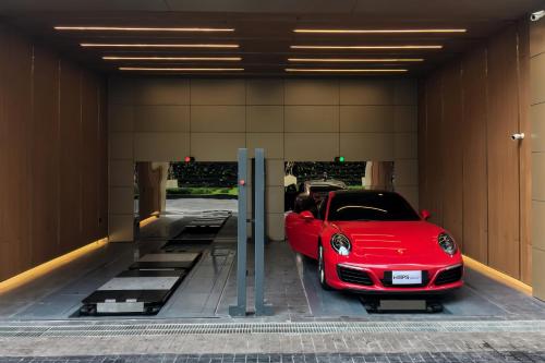 a red car is parked in a garage at Hyde Sukhumvit 11 Bangkok in Bangkok