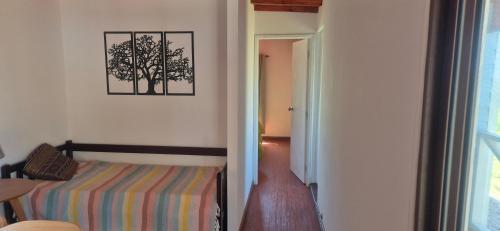 a bedroom with a bed and a picture on the wall at Altos de Vella Bista in Bella Vista