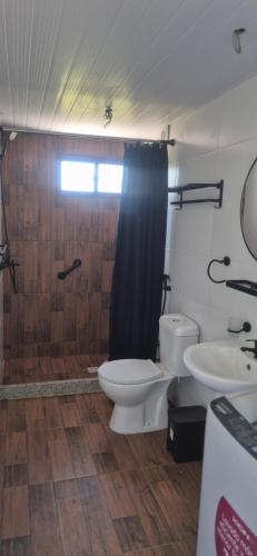 a bathroom with a shower and a toilet and a sink at Altos de Vella Bista in Bella Vista