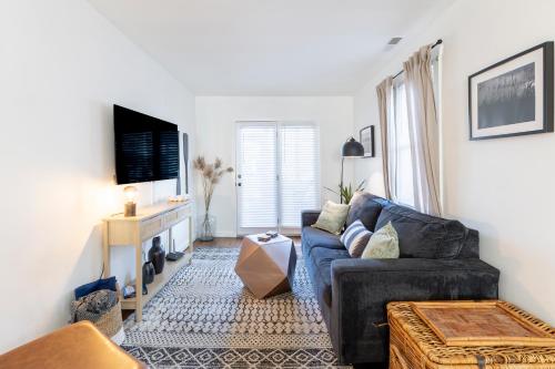 a living room with a couch and a tv at Cozy Beach Cottage Near The Bay in Villas