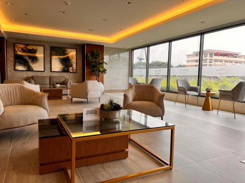 a living room with couches and a table and chairs at SMDC Green 2 Staycation, The Traditional & Modern Fusion Condo in Pasong Bayog